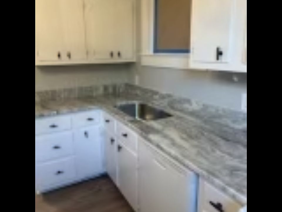 Kitchen new quartz countertop and attractive newly painted gray wall with white trim is found all throughout the home.