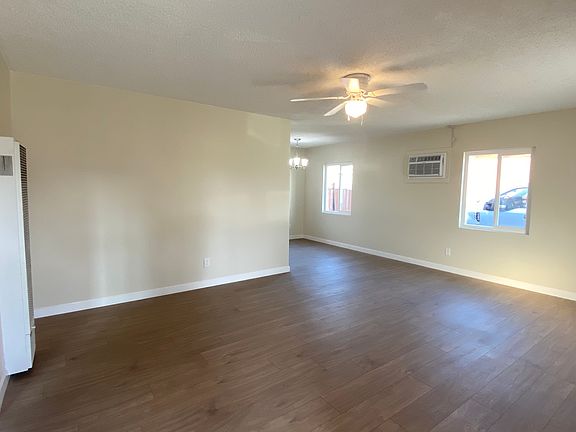Large living room with wall heater and brand new wall AC