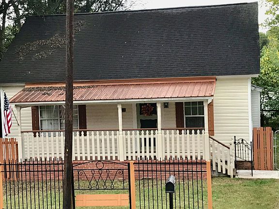Notice copper roof and decorative iron fence