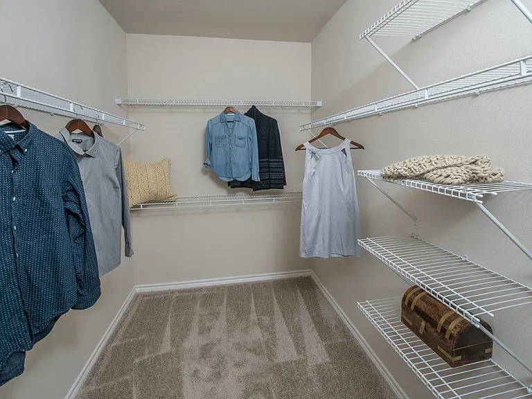 Your spacious walk-in closet with shelving will make organization easy