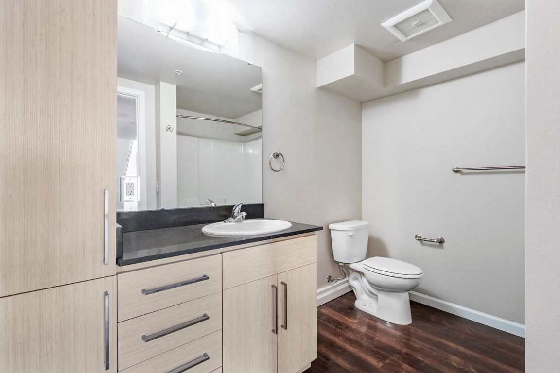 Experience the comfort of a modern bathroom equipped with sleek fixtures and ample lighting, offering a relaxing space.
