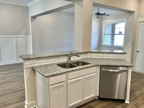 Stock photo showing kitchen highbar looking out from kitchen into great room and dining area. every