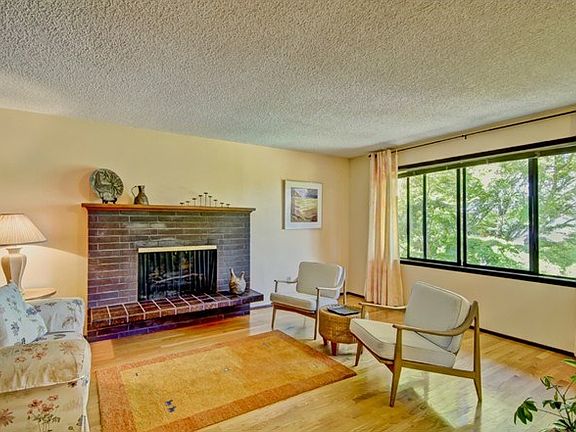 Formal Living room features a wall of west facing windows, peek