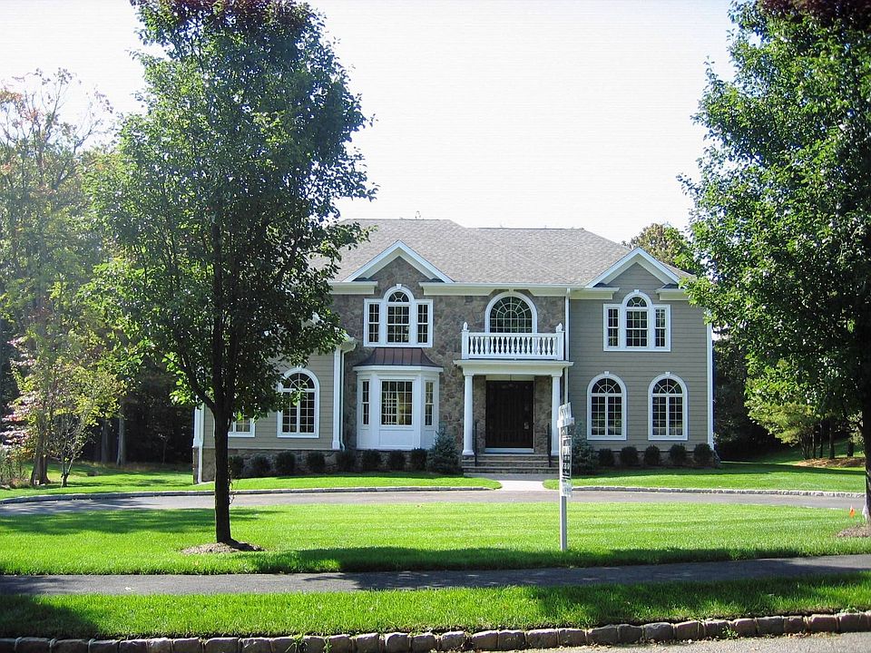 Front of house features a circular driveway and 3 car garage