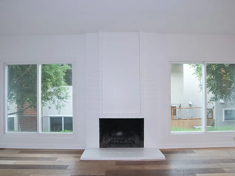 Living Room with hardwood floors and wood-burning fireplace.