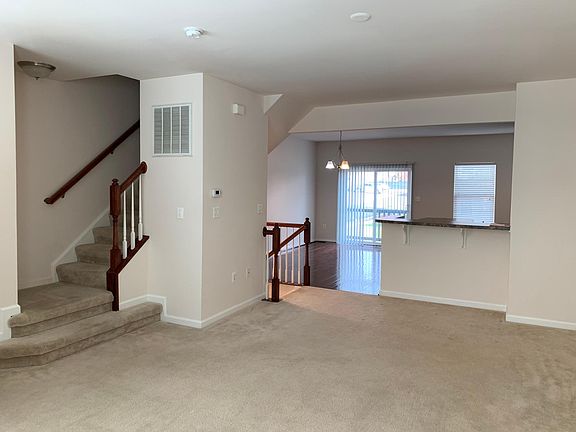 Living room with half bath, looking into dining room/kitchen