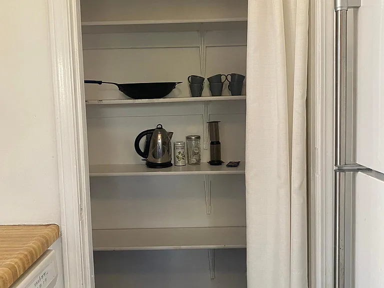 This walk-in pantry gives this kitchen a lot of storage and makes it very functional for cooking.