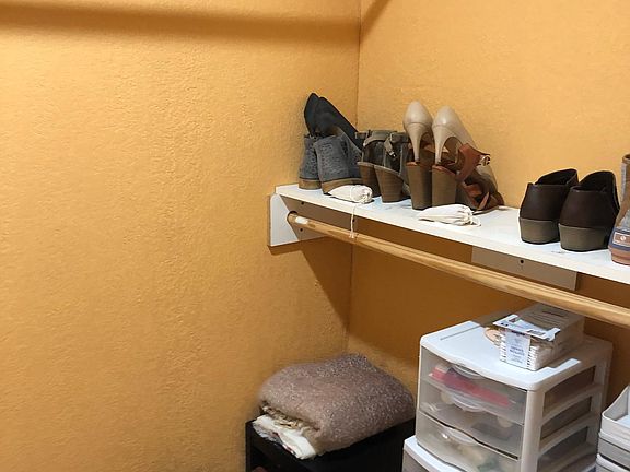 View of one of the two walk-in closets in the master en suite