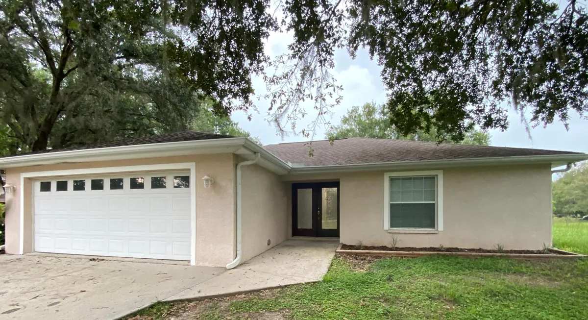 Front home exterior with extra large garage. - 7634 Tallowtree Dr