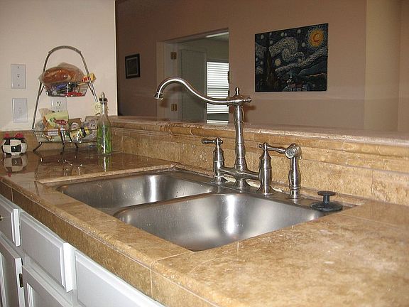 Travertine counters and new plumbing fixtures