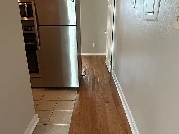 Hallway from living room to fully equipped kitchen