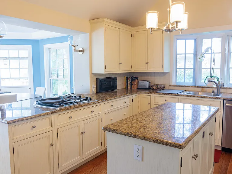Beautiful chef's kitchen with center island and ample cabinet space.
