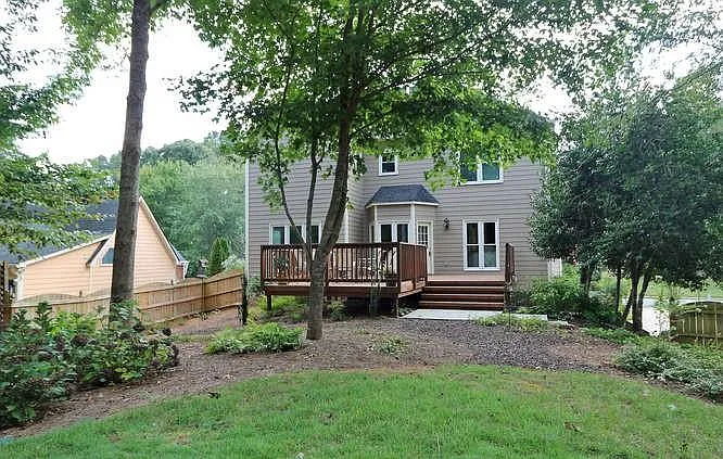 Idyllic carefully manicured back yard features an irrigation system.