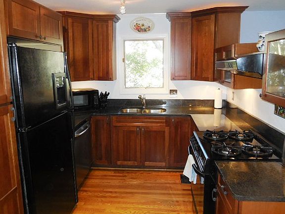 Renovated kitchen with Cherry wood cabinets, black and stainless appliances (gas stove)!