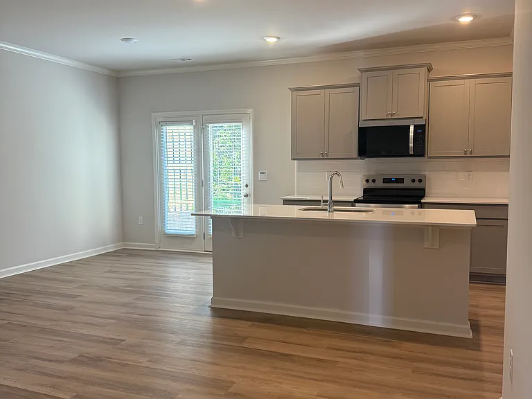 Kitchen leads to outdoor patio and private space.