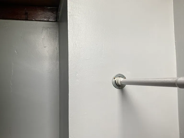 Spare bedroom closet side view with shelf