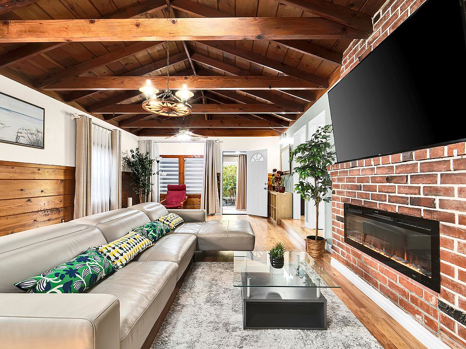 Very spacious, vaulted ceiling family room with 70 inches TV, and a modern fire place.