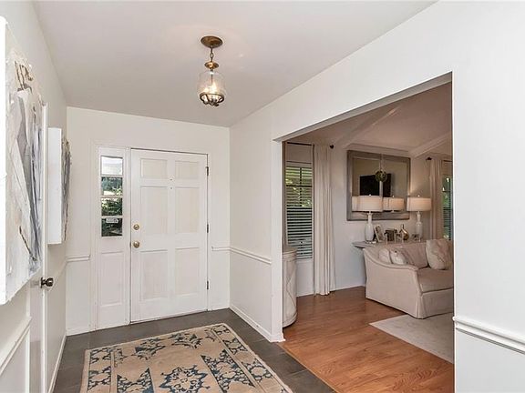 Living room with vaulted ceilings and a wood burning fireplace.