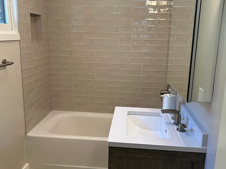 Tiled shower/tub area.