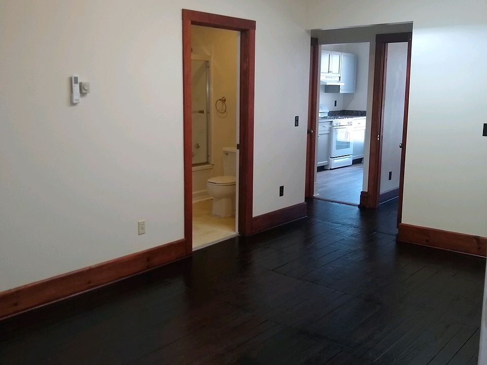 VIew as you enter the apartment. Hardwood floors throughout (kitchen has luxury vinyl tile). Kitchen is straight ahead in this photo, with bathroom on left and bedroom to the right of the kitchen. Note the widows watch letting in lots of light.