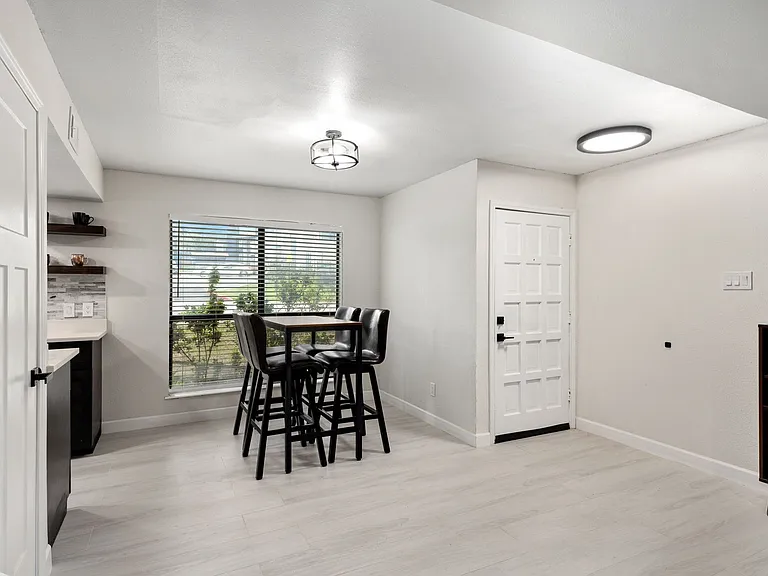Dining room featuring light wood-type flooring and bar area