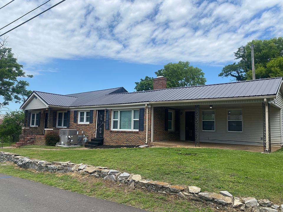 Large lovely brick home on a corner lot with a large attached carport!