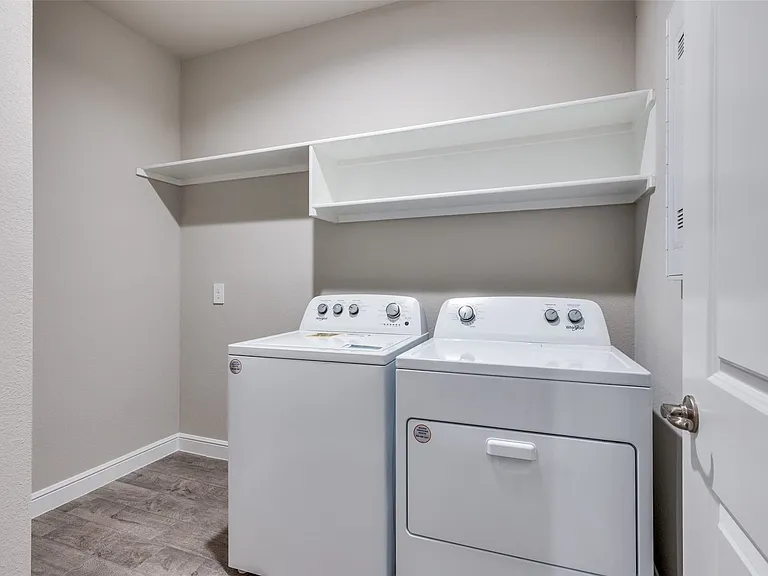 Laundry area with washer and dryer and light wood-type flooring