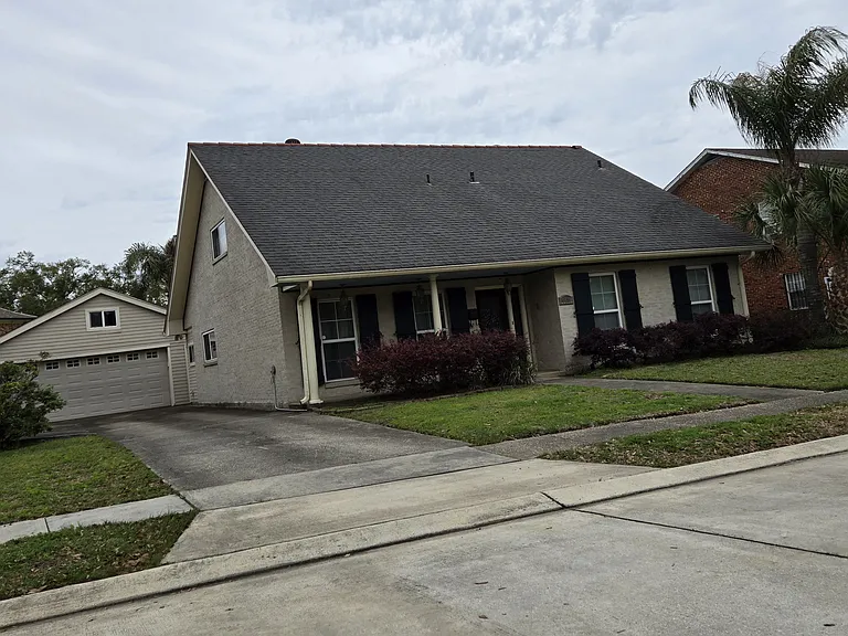 The front of the house with functional 
storm shutters and offscreen parking.