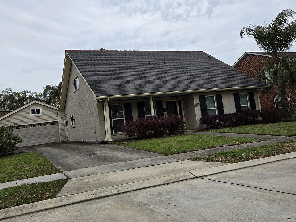 The front of the house with functional 
storm shutters and offscreen parking.