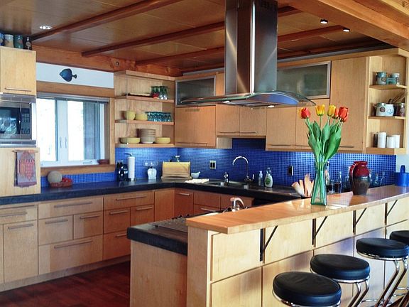 Open, light kitchen with concrete countertops