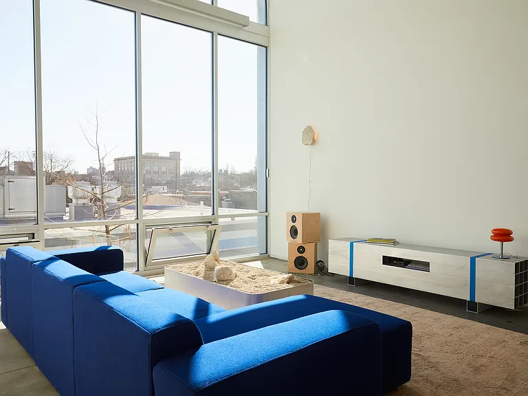 Living room with couch art deco coffee and sofa table with floor to ceiling windows