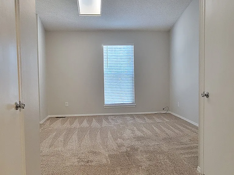 Master bedroom with 2 walk-in closets and skylight.