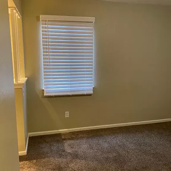 Master bed with new carpet and privacy blind