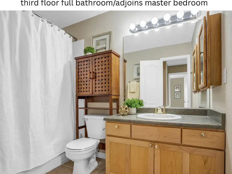 Top floor bathroom with different shower curtain