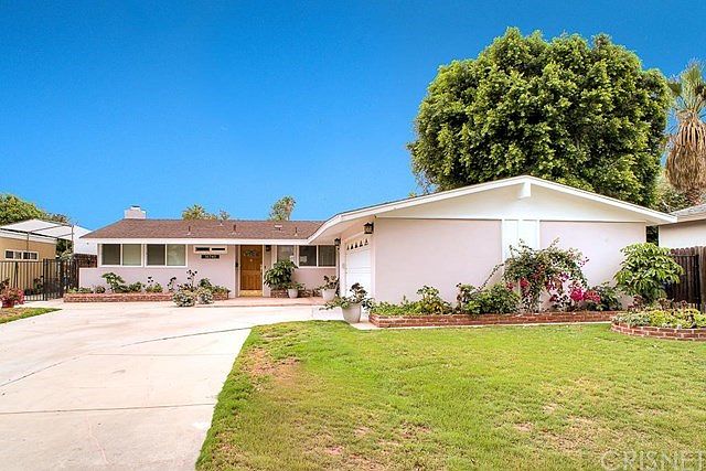 This home features handsome curb appeal with cement driveway, a two car attached garage with direct 