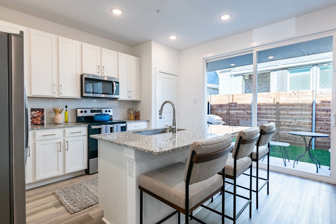 Embrace the modern convenience of a single-basin sink paired with a sleek pull-down faucet.