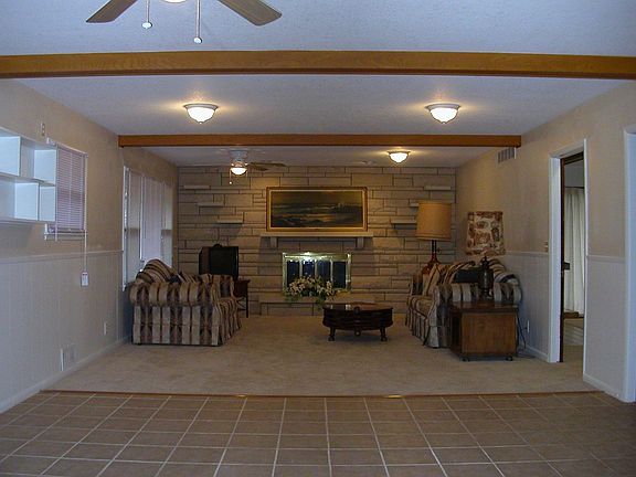 View from kitchen through large dining area to family room