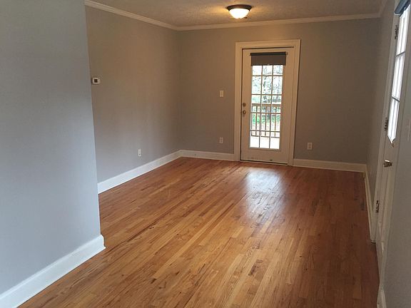 View of living room and covered porch access from dining area.