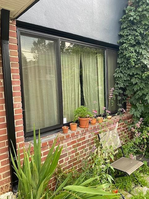 Unit #1 window overlooking front yard patio