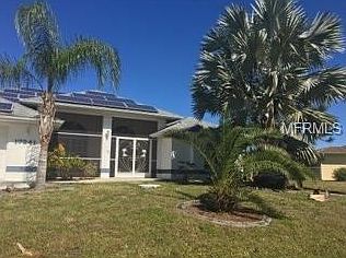 Front of home.  Check out the huge Bismark palm and tropical landscaping.