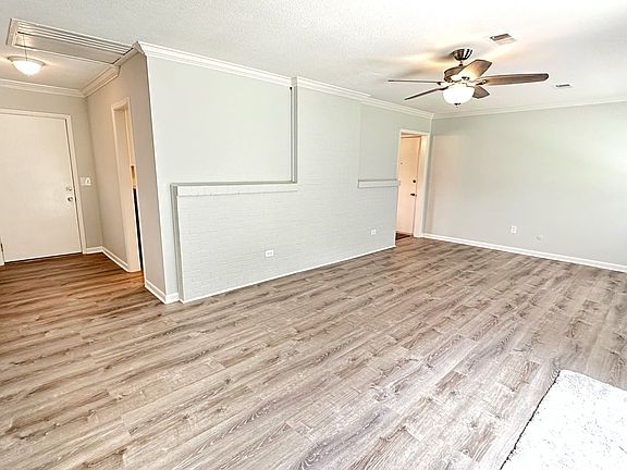 Large family room with sliding glass door exiting to the patio. New flooring has been installed in home.