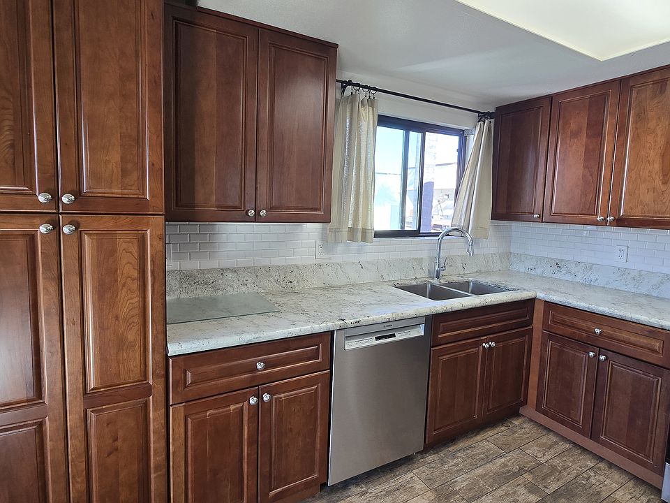 Kitchen This beautiful kitchen features stunning hardwood cabinets, offering ample storage space and a warm, inviting feel. The layout is both practical and stylish.