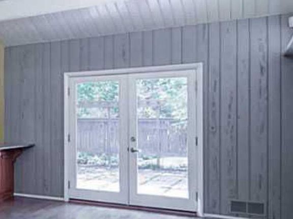 French doors in den/fireplace room out to side deck/hardwoods