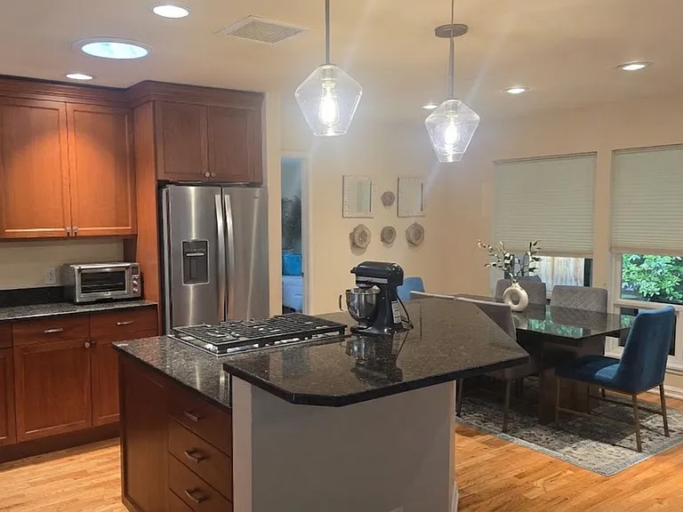 Open layout kitchen with gas stovetop.