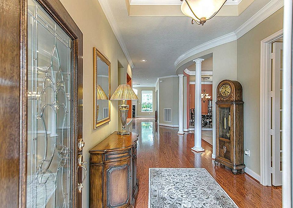 Leaded glass door, gleaming hardwood floors, decorative columns, tray ceilings, chandelier and crown moldings welcome you into your new home!