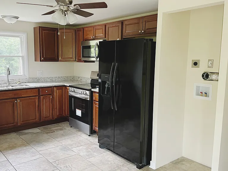 New, full size stackable washer/dryer provided