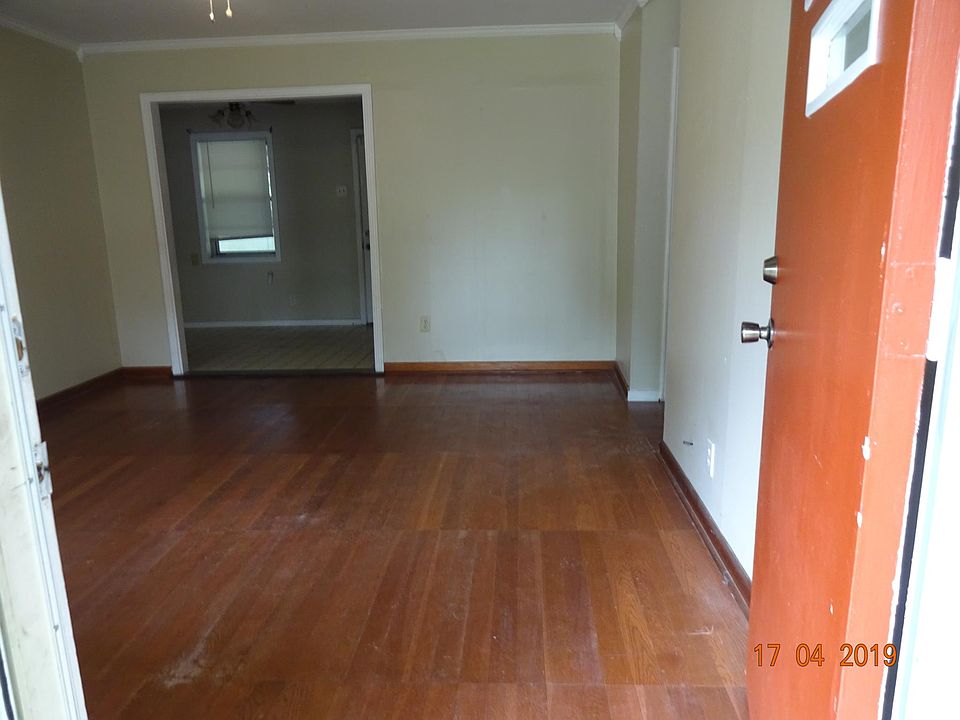Living room from front door straight ahead into the kitchen/dining room area to the right, the hallway to the bedrooms