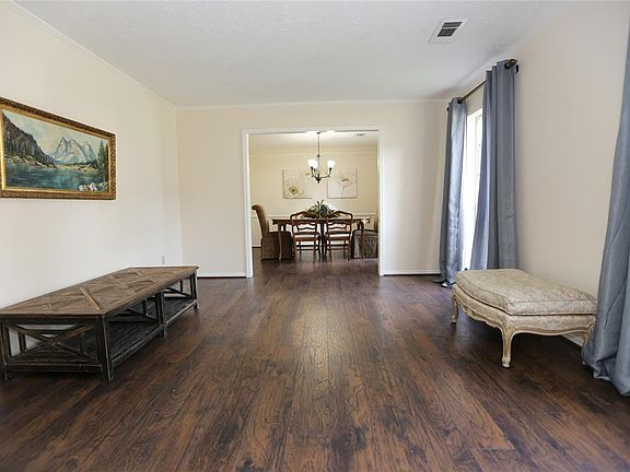 This formal living is spacious, and could easily be used as an office space or play room.