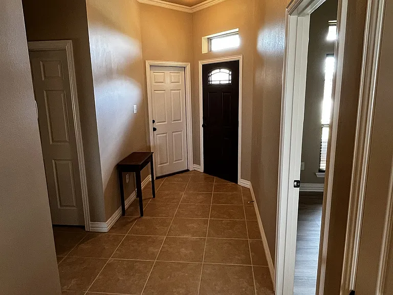 hallway to front entrance and garage door to two car garage