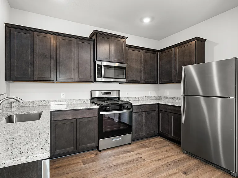 The kitchen of the Hawthorn has beautiful wood cabinetry.